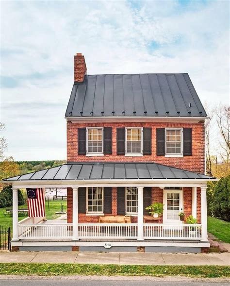 2 story house with porch with metal roofing|two story metal exterior home.